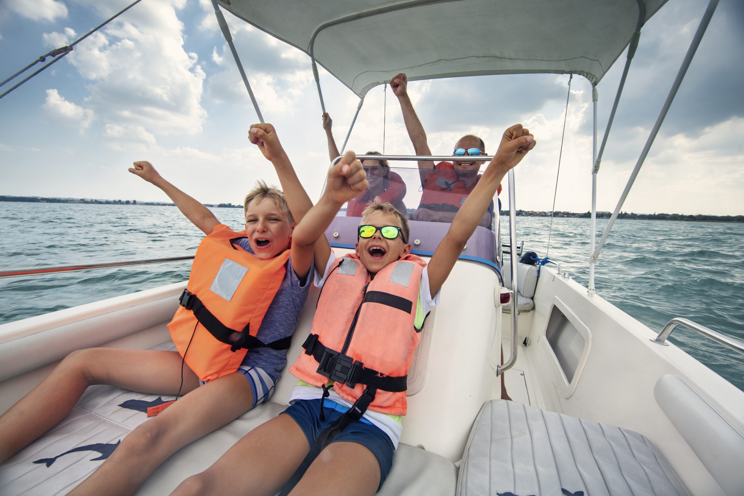Family enjoying Garda Lake vacations. Parents and kids riding a boat on Lake Garda.
Nikon D850